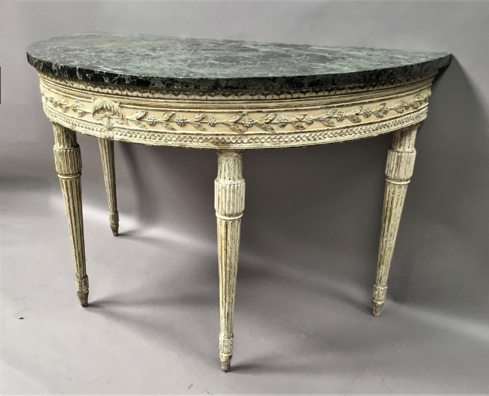 An 18th-century Italian Neoclassical demilune console table featuring an off-white painted timber frame with fluted tapered legs and a dark green marble top. View III