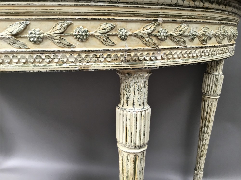 An 18th-century Italian Neoclassical demilune console table featuring an off-white painted timber frame with fluted tapered legs and a dark green marble top. View VII