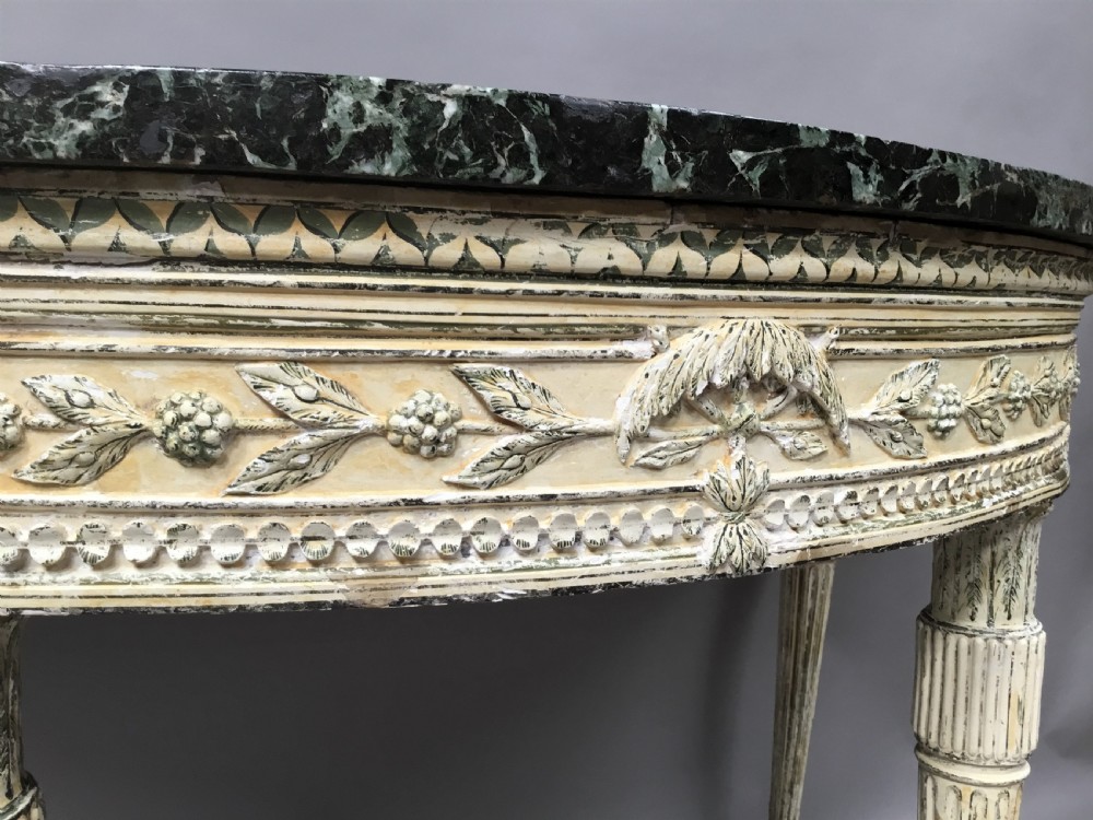 An 18th-century Italian Neoclassical demilune console table featuring an off-white painted timber frame with fluted tapered legs and a dark green marble top. View VIII