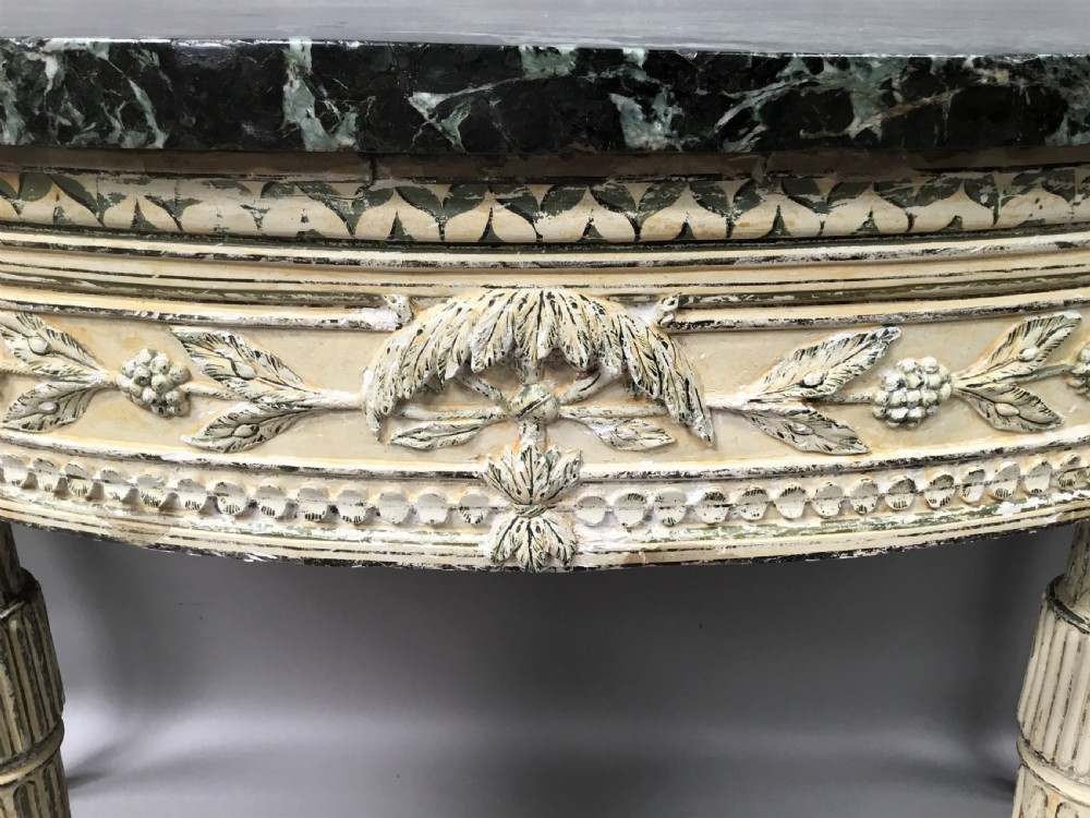 An 18th-century Italian Neoclassical demilune console table featuring an off-white painted timber frame with fluted tapered legs and a dark green marble top. View XI