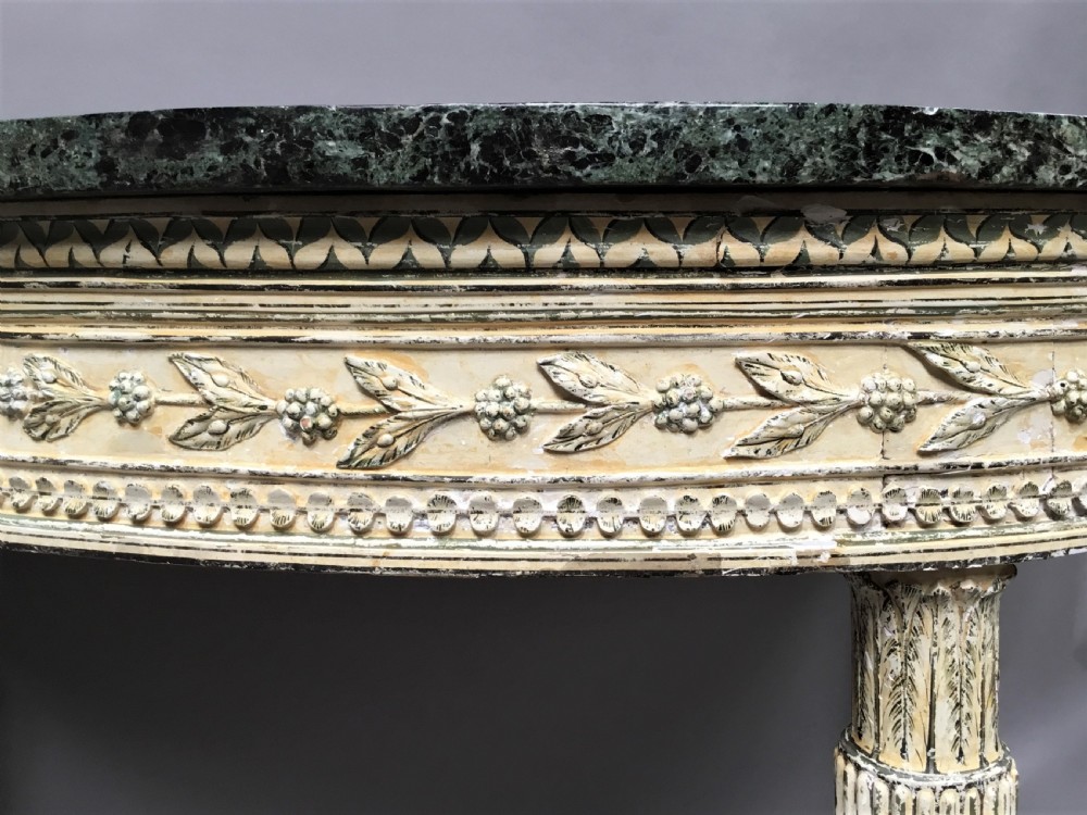 An 18th-century Italian Neoclassical demilune console table featuring an off-white painted timber frame with fluted tapered legs and a dark green marble top. View XII