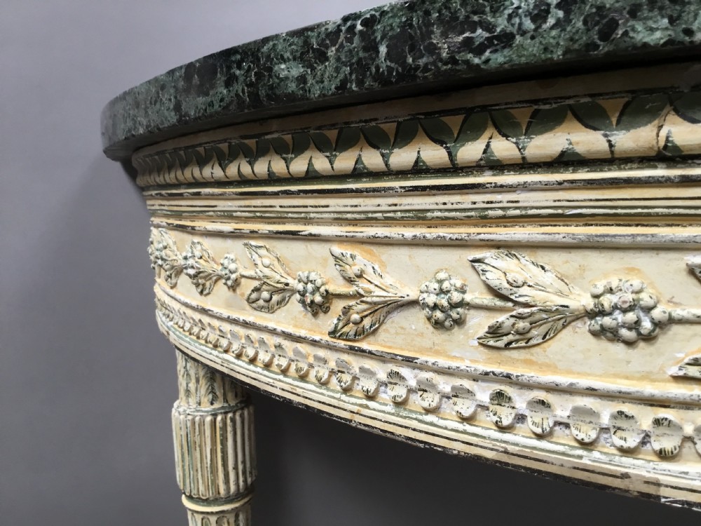 An 18th-century Italian Neoclassical demilune console table featuring an off-white painted timber frame with fluted tapered legs and a dark green marble top. View XIII