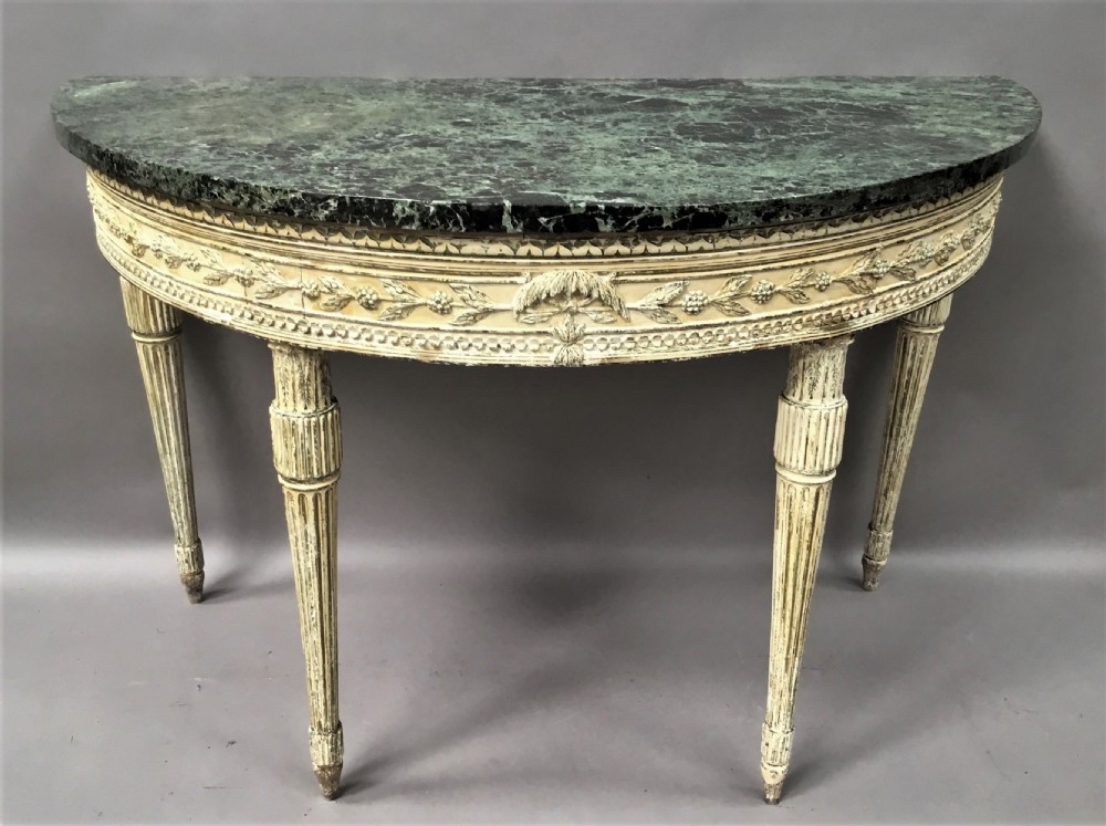 An 18th-century Italian Neoclassical demilune console table featuring an off-white painted timber frame with fluted tapered legs and a dark green marble top. View XVII