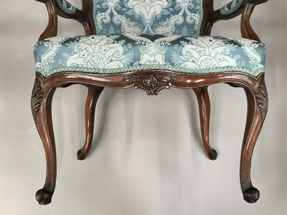 A pair of 18th-century Italian open armchairs featuring carved walnut frames, cabriole legs, and light blue damask pattern upholstery. View VIII