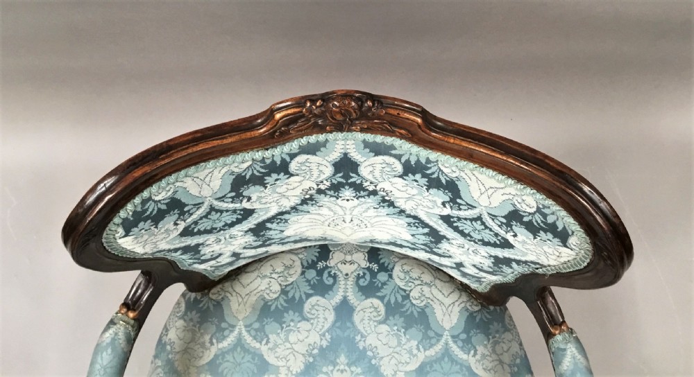 A pair of 18th-century Italian open armchairs featuring carved walnut frames, cabriole legs, and light blue damask pattern upholstery. View XI