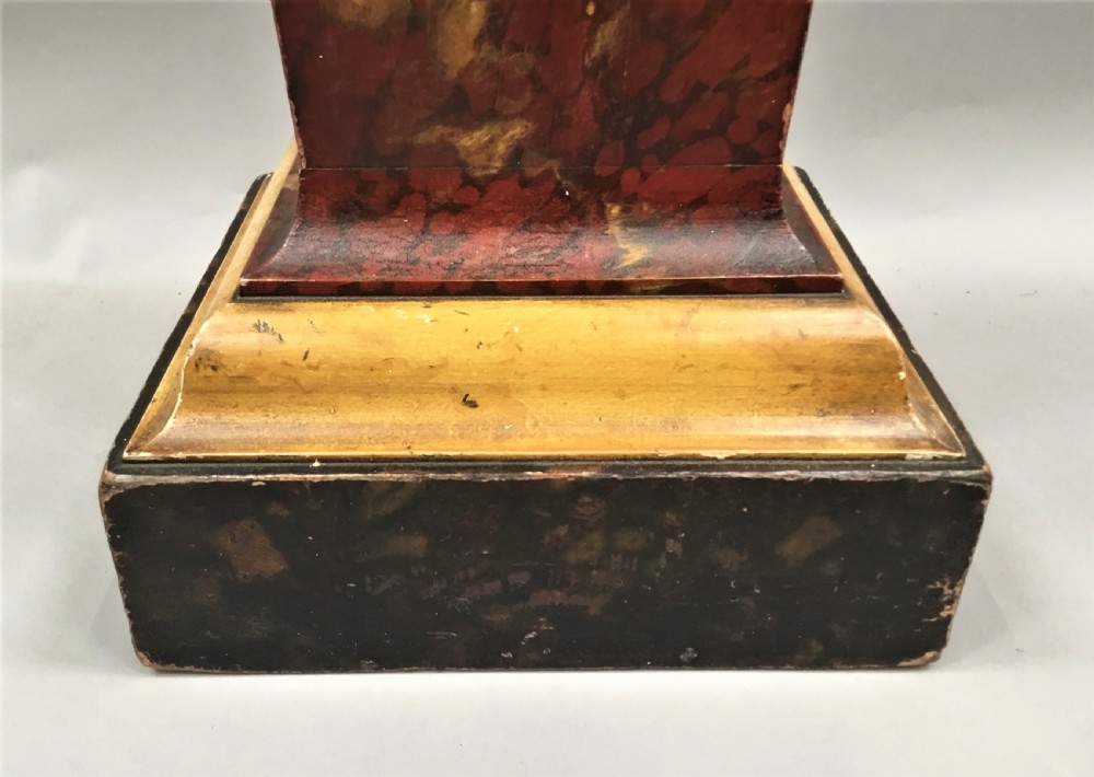 A tall tapering wooden display pedestal with a red faux-marble painted finish and gilded stepped mouldings at the top and base. View XIII