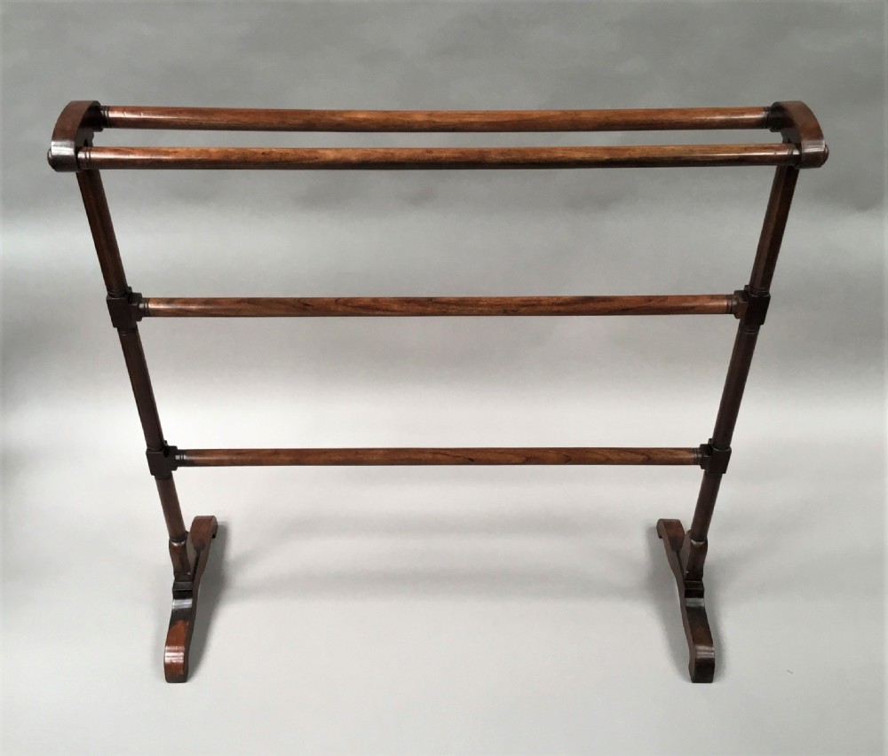 A Regency mahogany freestanding towel rail featuring turned horizontal rails and sledge feet. View X