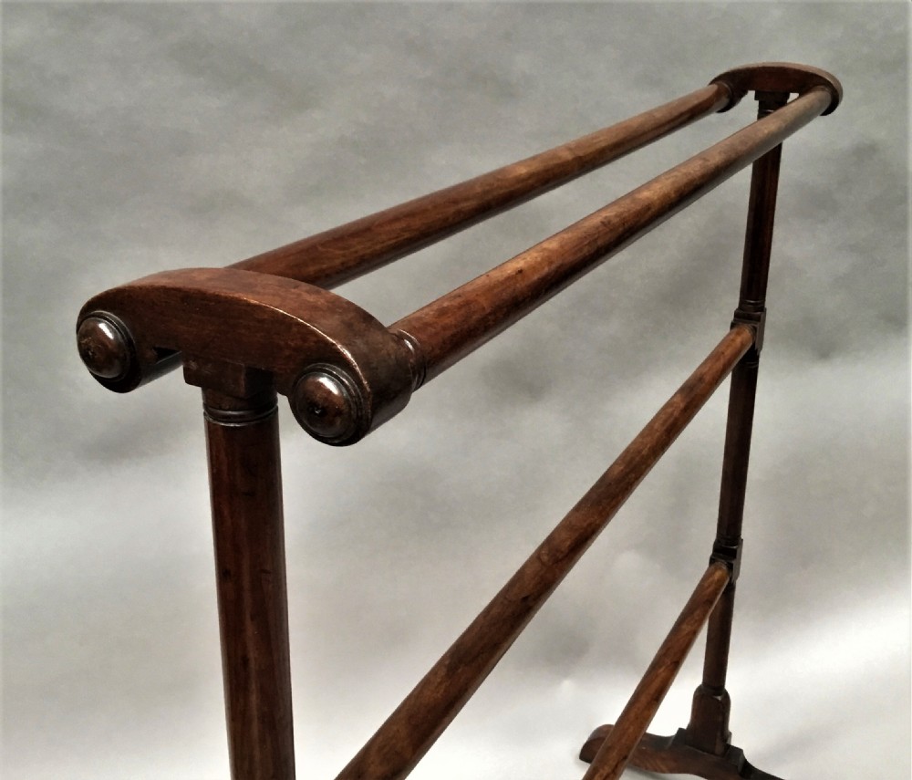 A Regency mahogany freestanding towel rail featuring turned horizontal rails and sledge feet. View XI
