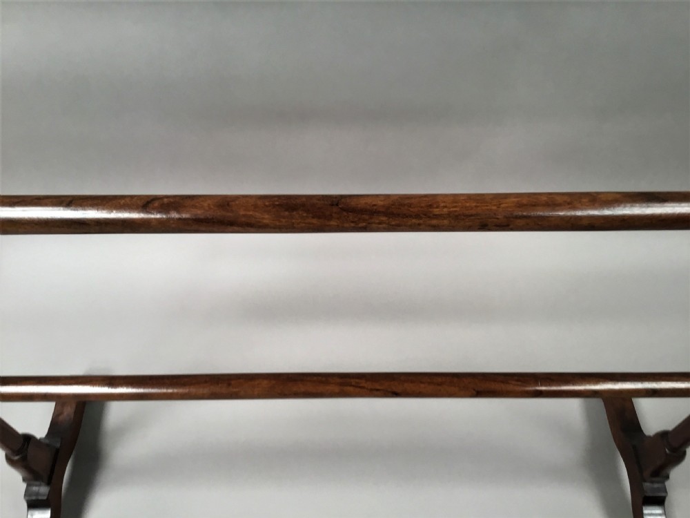 A Regency mahogany freestanding towel rail featuring turned horizontal rails and sledge feet. View XII