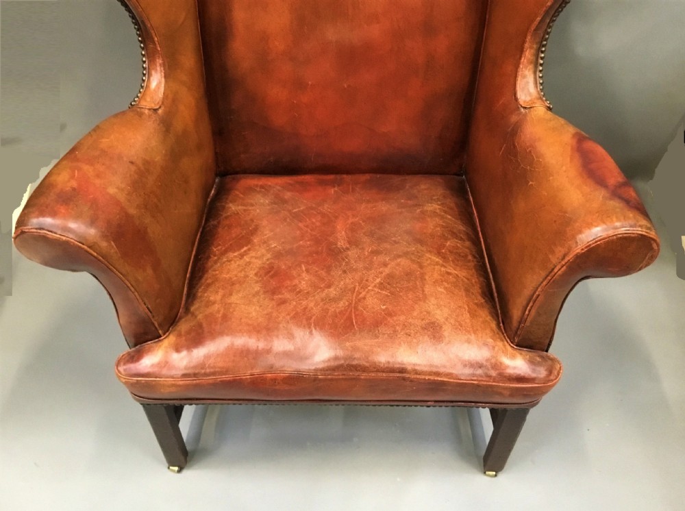 George III mahogany and leather wing chair of generous proportions View IV