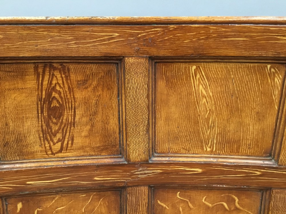 An antique Georgian high-backed wooden settle featuring a curved panelled back with a warm brown scumbled painted finish and integrated seat. View III