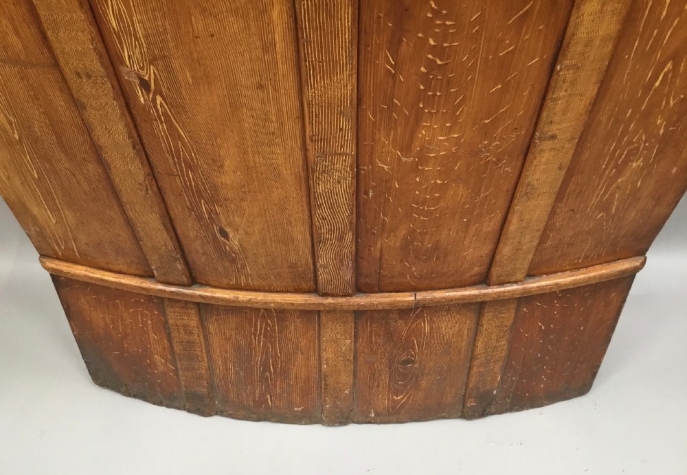 An antique Georgian high-backed wooden settle featuring a curved panelled back with a warm brown scumbled painted finish and integrated seat. View XXII