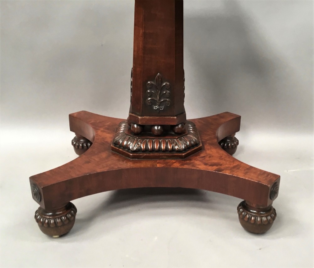 A Regency mahogany centre table featuring a rounded square top with rope-twist carved moulding, supported by a central tapered pedestal and a quadform base with lobed feet. View XIV