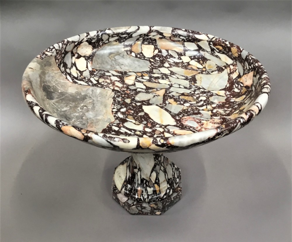 A large 19th-century Neoclassical tazza carved from variegated brecciated marble featuring a shallow wide bowl on a turned stem and octagonal base. View V