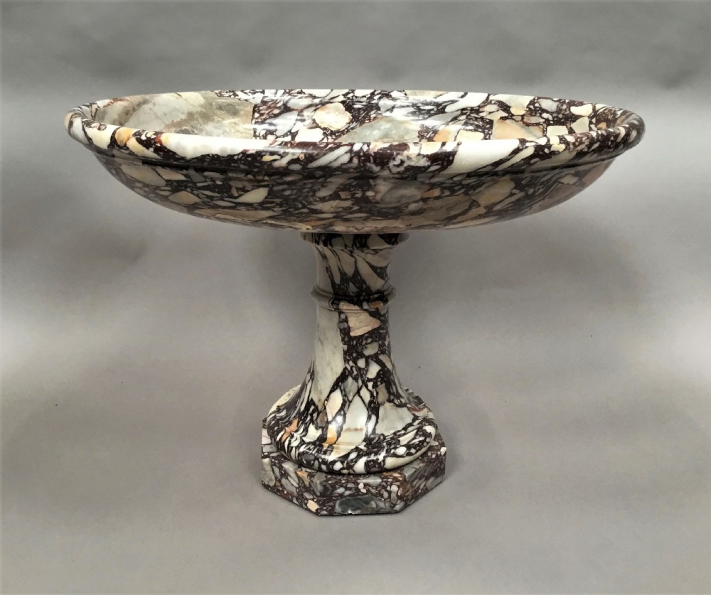 A large 19th-century Neoclassical tazza carved from variegated brecciated marble featuring a shallow wide bowl on a turned stem and octagonal base. View VII
