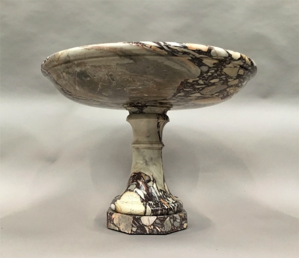 A large 19th-century Neoclassical tazza carved from variegated brecciated marble featuring a shallow wide bowl on a turned stem and octagonal base. View XIII