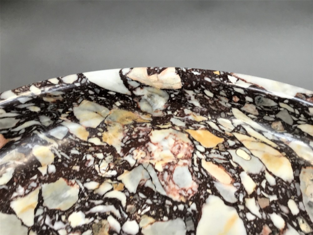 A large 19th-century Neoclassical tazza carved from variegated brecciated marble featuring a shallow wide bowl on a turned stem and octagonal base. View XVI