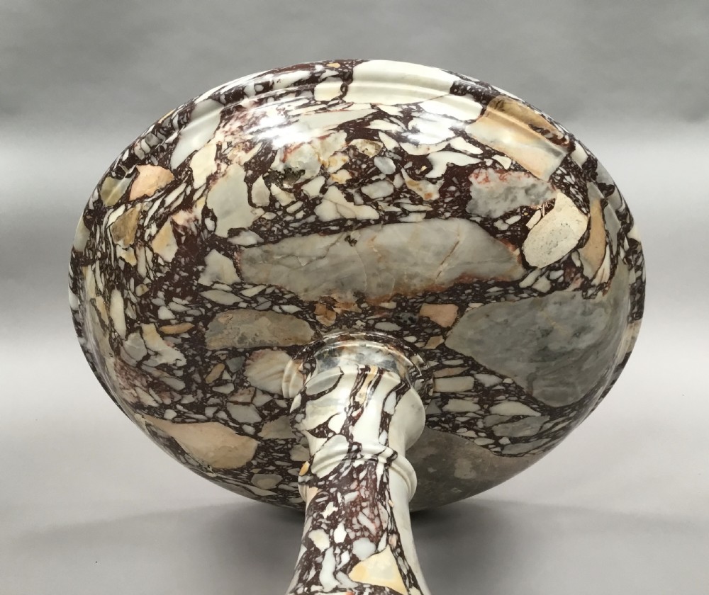 A large 19th-century Neoclassical tazza carved from variegated brecciated marble featuring a shallow wide bowl on a turned stem and octagonal base. View XVIII