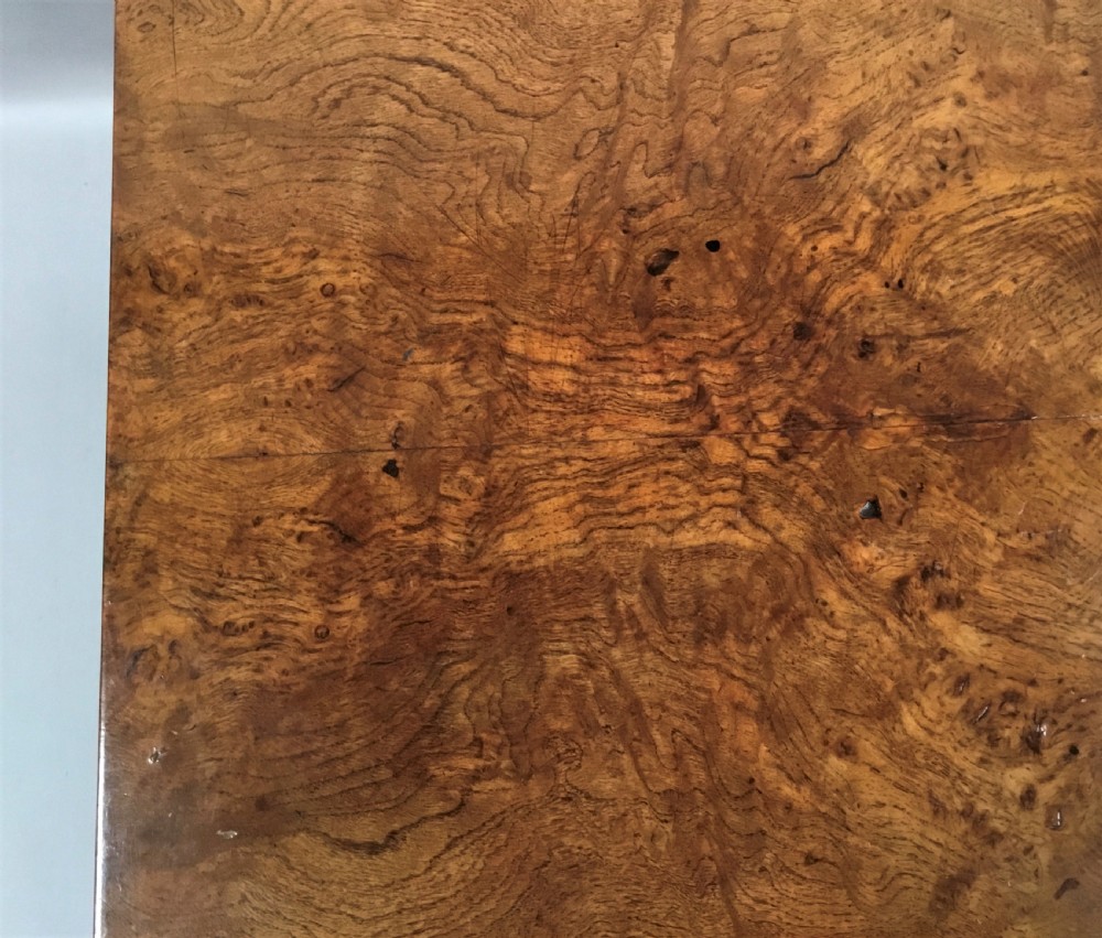 A Regency burr oak drop-flap occasional table featuring lyre-shaped side supports, a single drawer, turned stretcher, and brass castors. View III