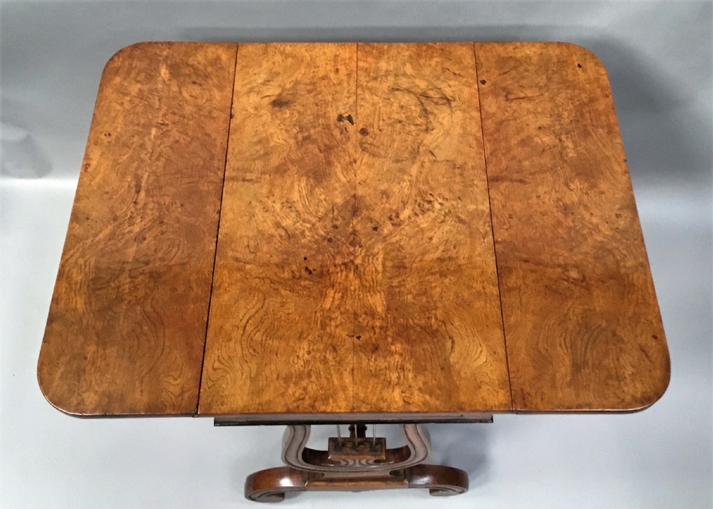 A Regency burr oak drop-flap occasional table featuring lyre-shaped side supports, a single drawer, turned stretcher, and brass castors. View VIII