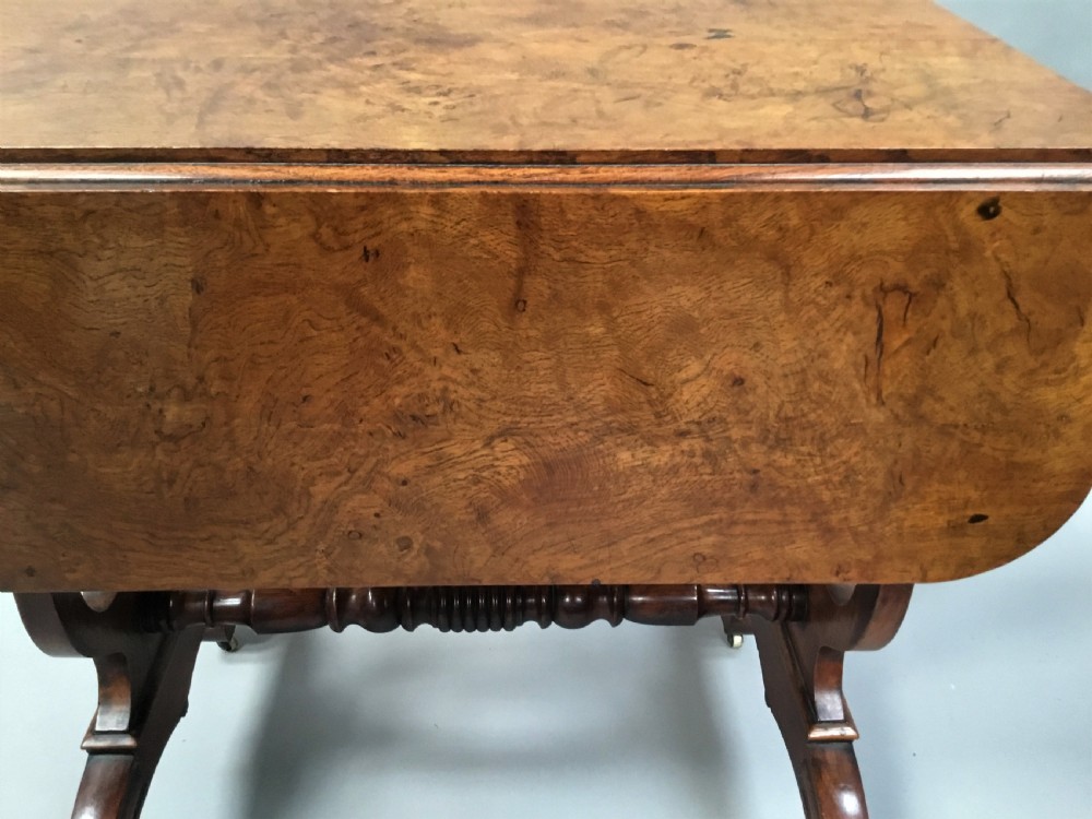 A Regency burr oak drop-flap occasional table featuring lyre-shaped side supports, a single drawer, turned stretcher, and brass castors. View XIII