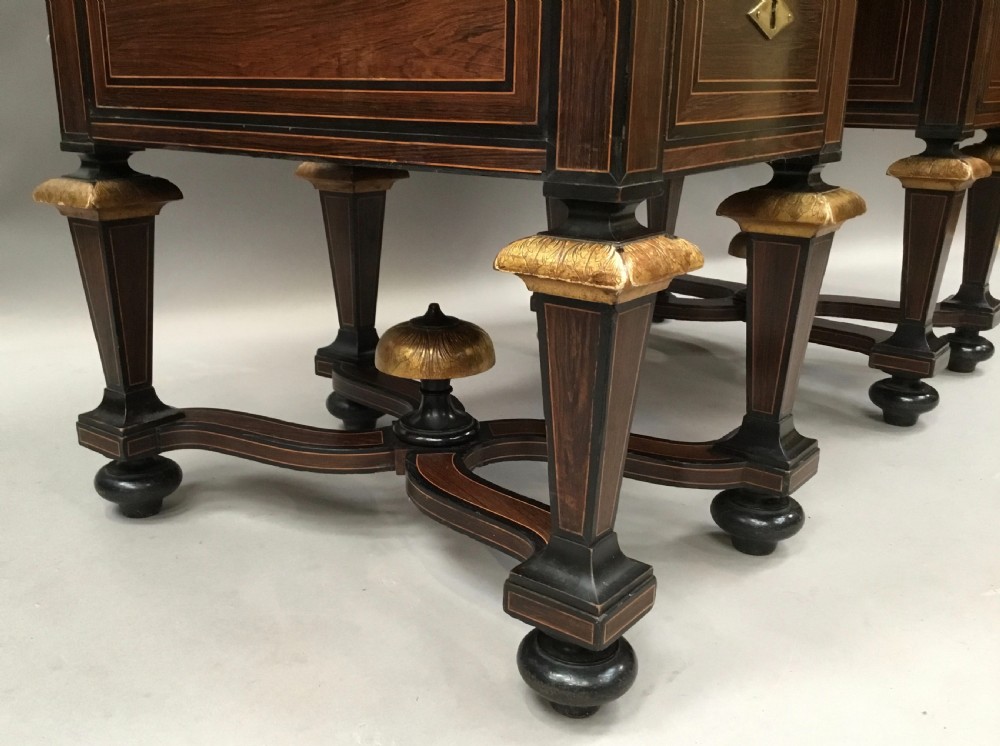 A 19th-century French rosewood kneehole desk featuring line inlay, brass escutcheons, a central recessed cupboard, and eight tapered legs connected by curved stretchers. View VI