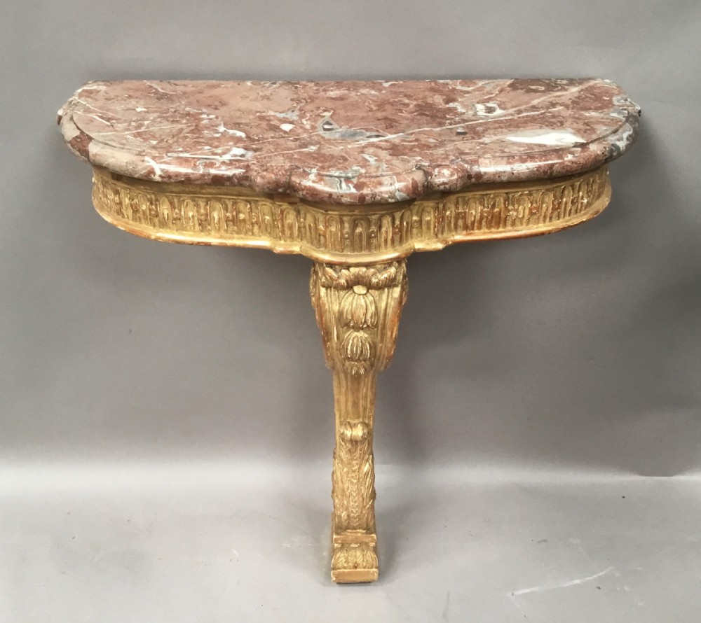 A 19th-century French Louis XV style wall-mounted giltwood console table featuring a carved single scroll leg and a shaped pink marble top. View II