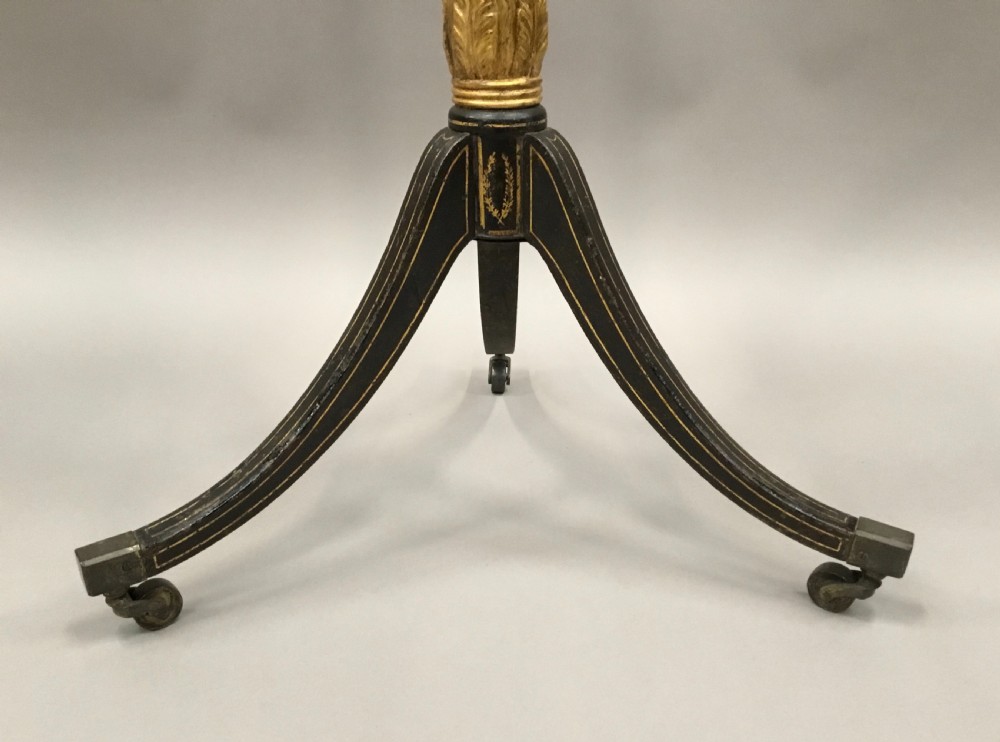 A tall Regency period octagonal torchere stand featuring a black and gold lacquered tray top, reeded column, and tripod base. View XI