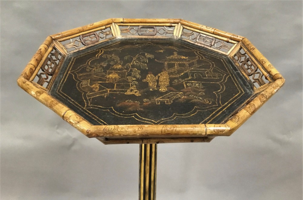 A tall Regency period octagonal torchere stand featuring a black and gold lacquered tray top, reeded column, and tripod base. View XIV