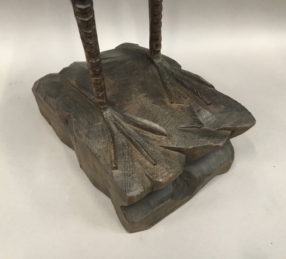 A nineteenth-century carved pine sculpture of a standing heron with detailed feather carving mounted on a sculpted wooden base. View XIII
