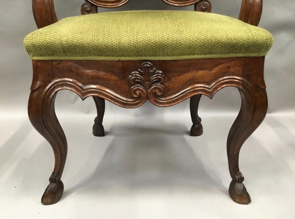 An 18th-century Italian carved walnut open armchair featuring a high upholstered backrest and seat in sage green textured fabric with cabriole legs. View IV