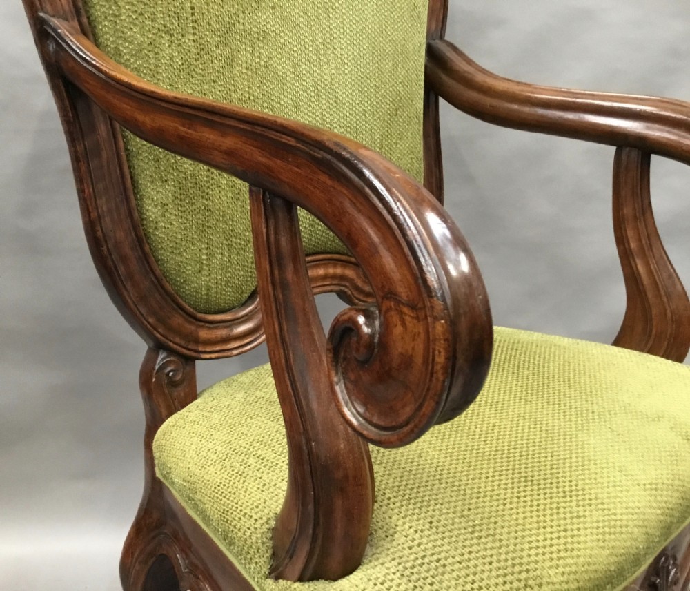 An 18th-century Italian carved walnut open armchair featuring a high upholstered backrest and seat in sage green textured fabric with cabriole legs. View V