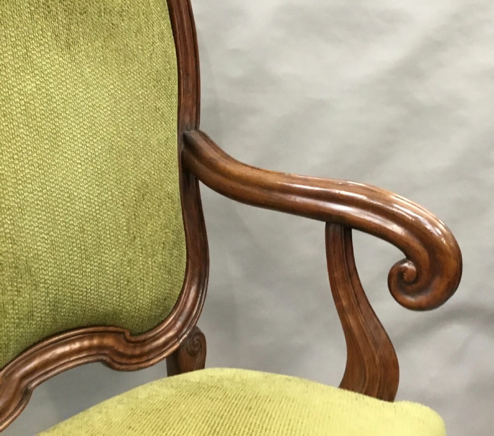 An 18th-century Italian carved walnut open armchair featuring a high upholstered backrest and seat in sage green textured fabric with cabriole legs. View XIII