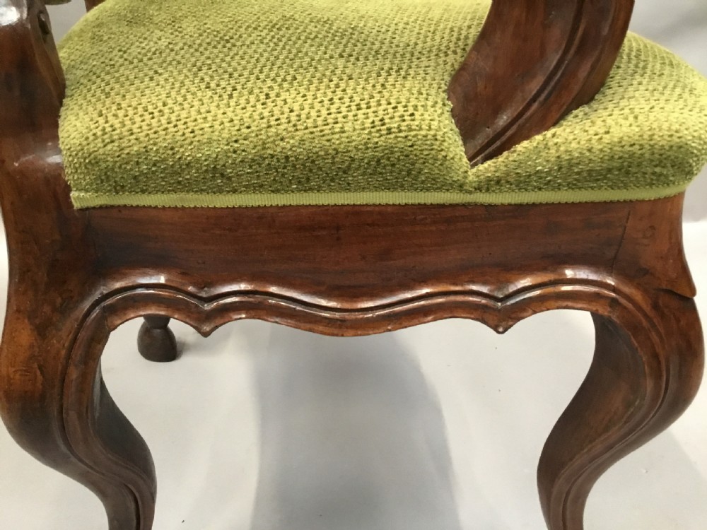 An 18th-century Italian carved walnut open armchair featuring a high upholstered backrest and seat in sage green textured fabric with cabriole legs. View XV