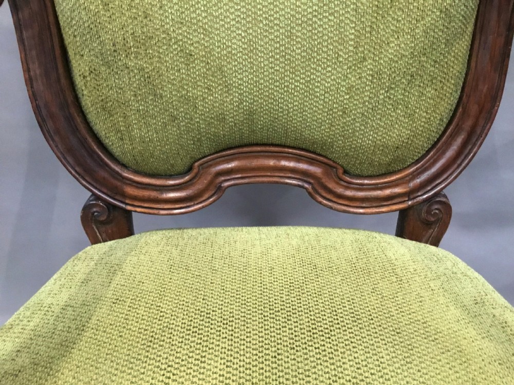 An 18th-century Italian carved walnut open armchair featuring a high upholstered backrest and seat in sage green textured fabric with cabriole legs. View XVII