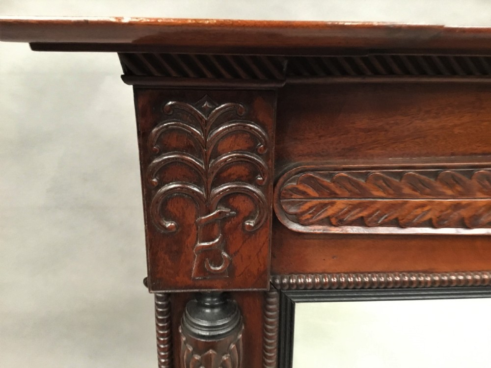 An antique Anglo-Indian carved teak overmantel mirror with spiral-turned columns, shell carving, and a wide rectangular glass panel. View X