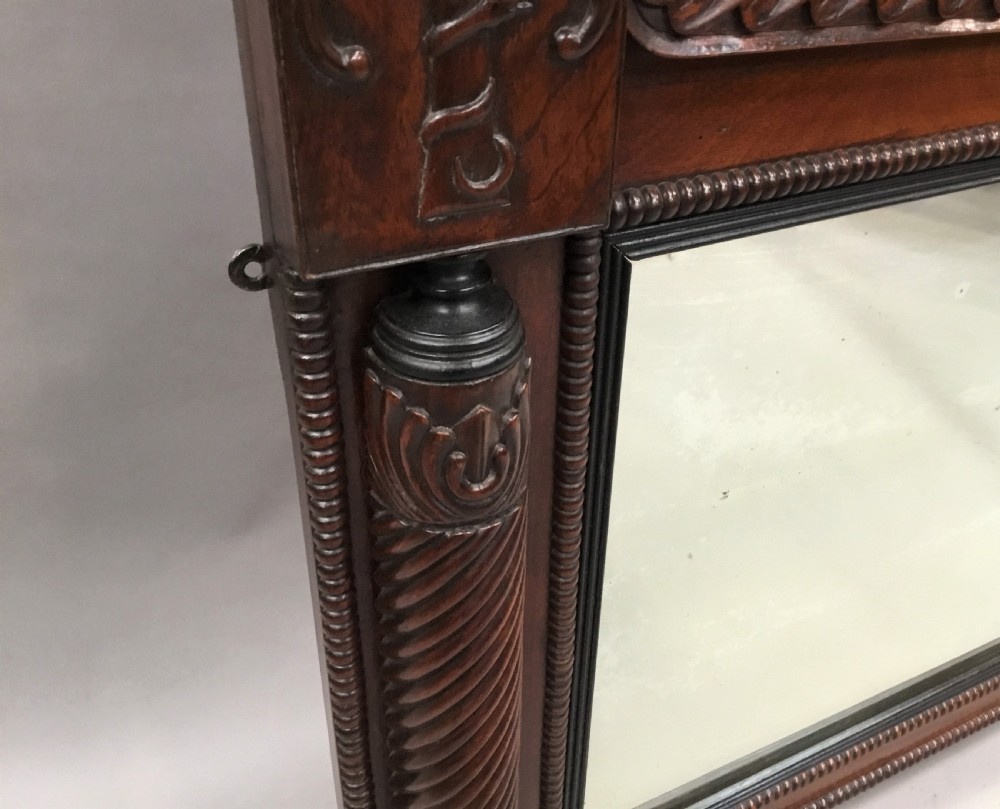An antique Anglo-Indian carved teak overmantel mirror with spiral-turned columns, shell carving, and a wide rectangular glass panel. View XI