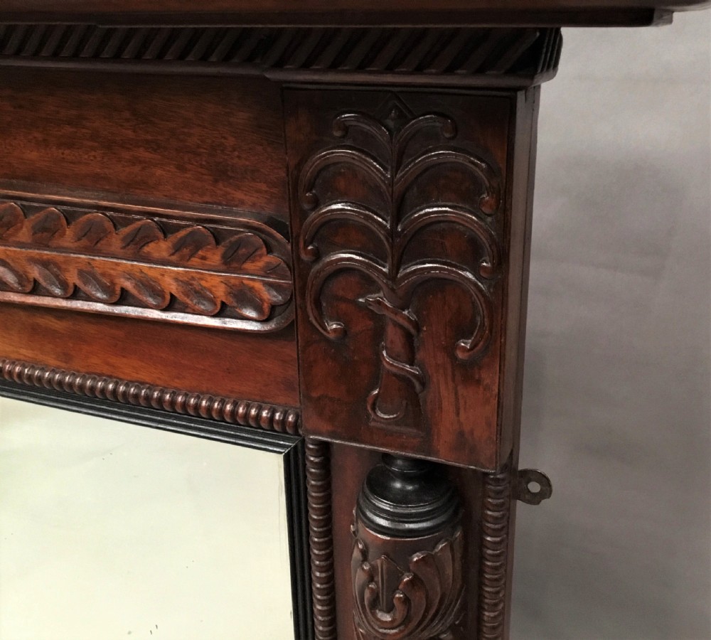 An antique Anglo-Indian carved teak overmantel mirror with spiral-turned columns, shell carving, and a wide rectangular glass panel. View XII