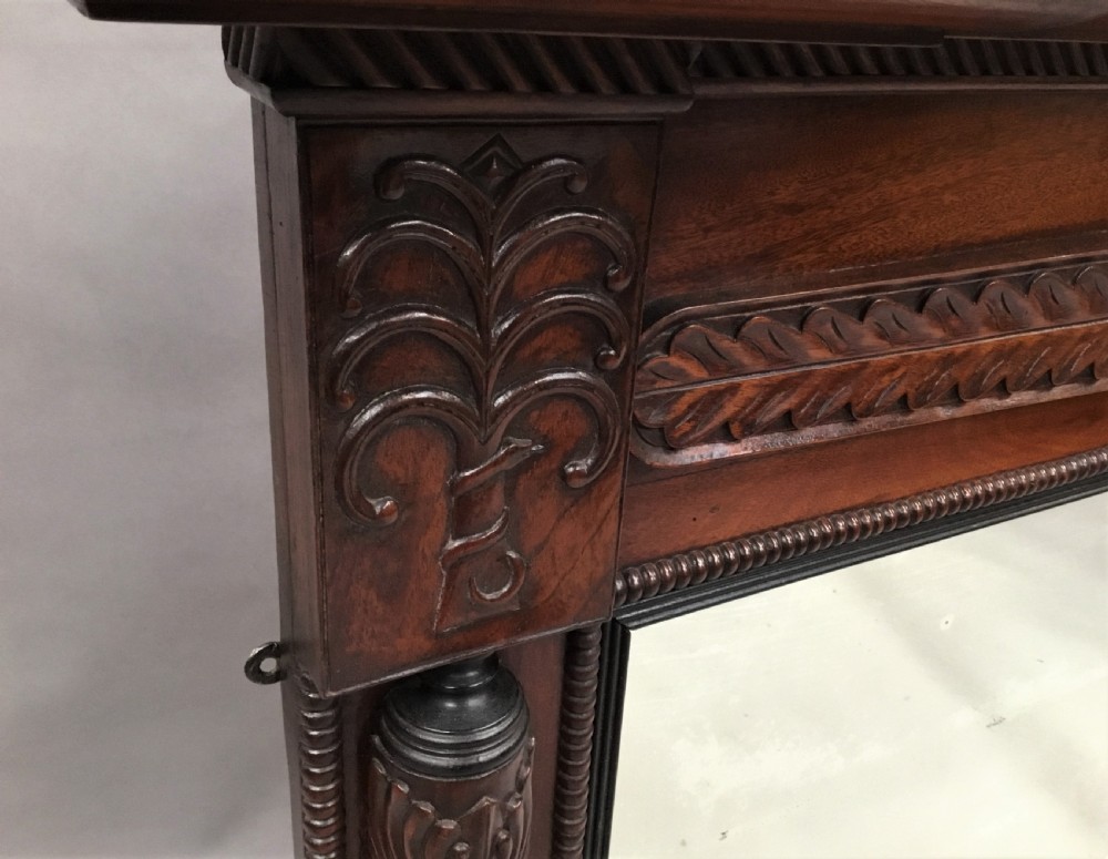 An antique Anglo-Indian carved teak overmantel mirror with spiral-turned columns, shell carving, and a wide rectangular glass panel. View XIII