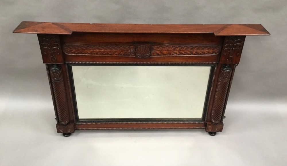 An antique Anglo-Indian carved teak overmantel mirror with spiral-turned columns, shell carving, and a wide rectangular glass panel. View XIV