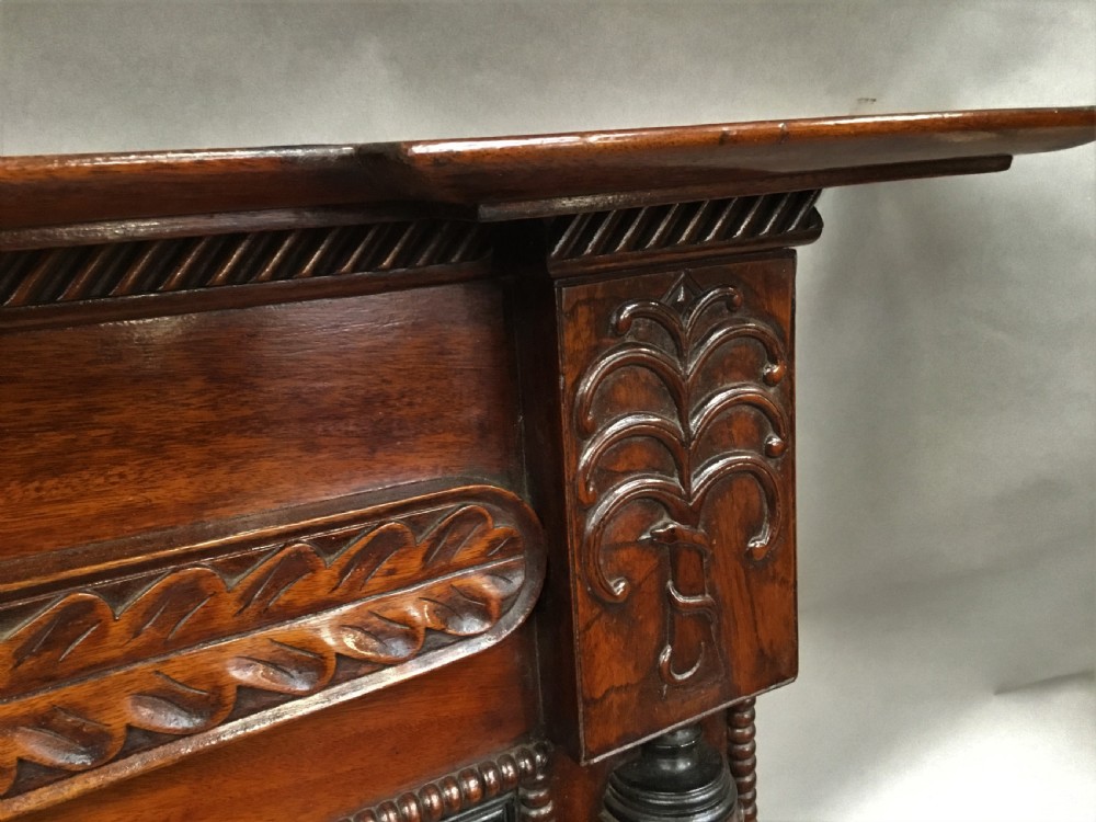 An antique Anglo-Indian carved teak overmantel mirror with spiral-turned columns, shell carving, and a wide rectangular glass panel. View XVI