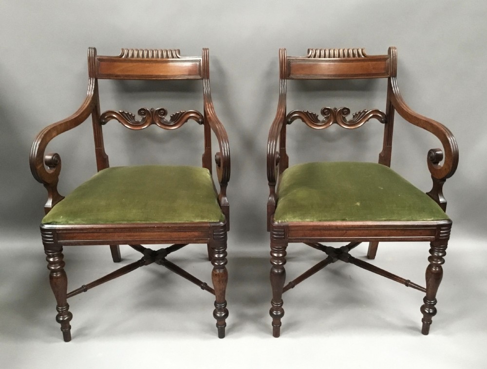 A pair of Regency mahogany open armchairs featuring scrolled armrests, turned front legs, and olive green velvet upholstered seats. View II