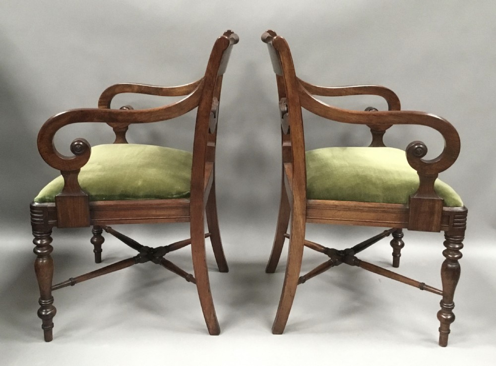 A pair of Regency mahogany open armchairs featuring scrolled armrests, turned front legs, and olive green velvet upholstered seats. View IV