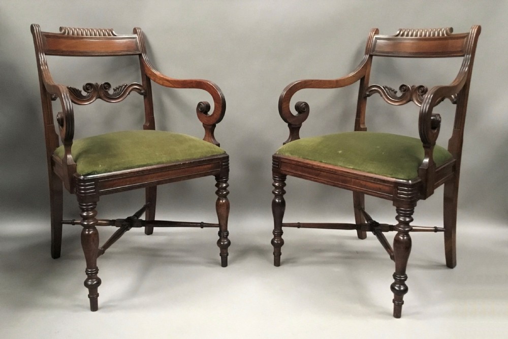 A pair of Regency mahogany open armchairs featuring scrolled armrests, turned front legs, and olive green velvet upholstered seats. View VI