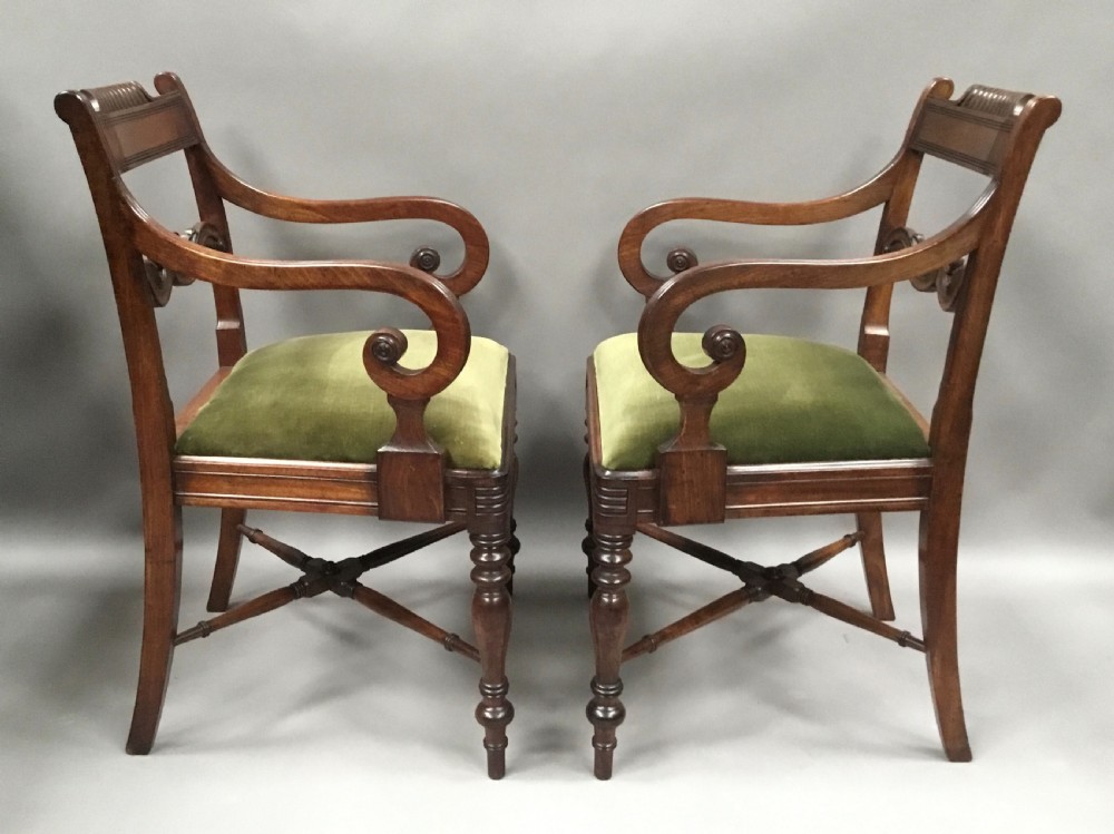 A pair of Regency mahogany open armchairs featuring scrolled armrests, turned front legs, and olive green velvet upholstered seats. View VII