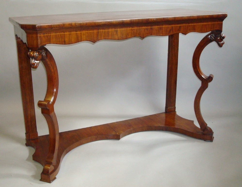 A pair of 19th-century Italian walnut console tables featuring carved zoomorphic legs, serpentine aprons with light string inlay, and lower curved stretchers. View II