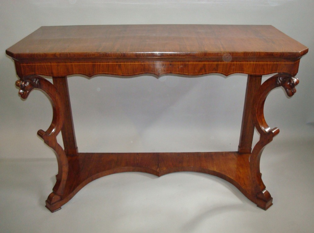 A pair of 19th-century Italian walnut console tables featuring carved zoomorphic legs, serpentine aprons with light string inlay, and lower curved stretchers. View III