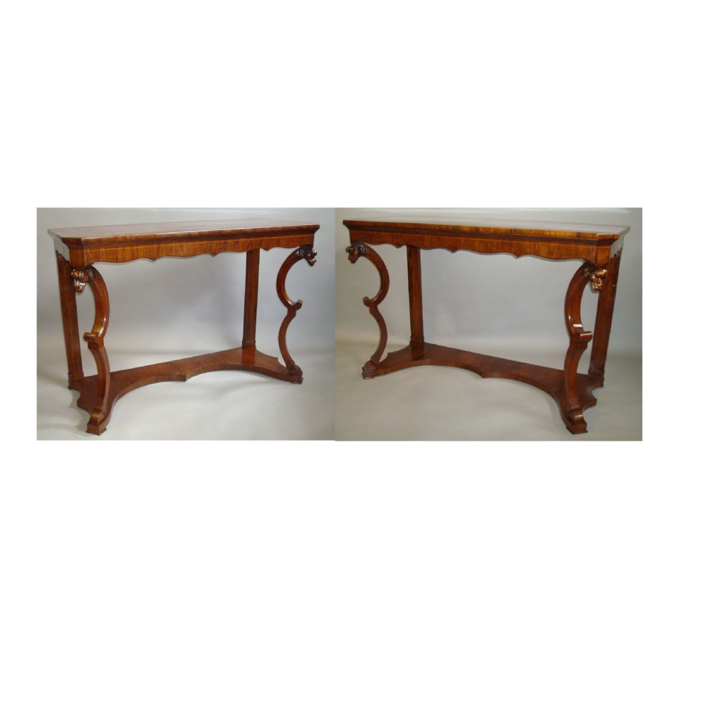 A pair of 19th-century Italian walnut console tables featuring carved zoomorphic legs, serpentine aprons with light string inlay, and lower curved stretchers. View V