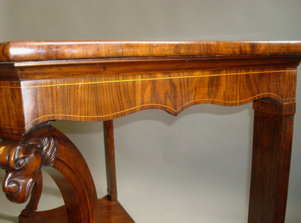A pair of 19th-century Italian walnut console tables featuring carved zoomorphic legs, serpentine aprons with light string inlay, and lower curved stretchers. View VI