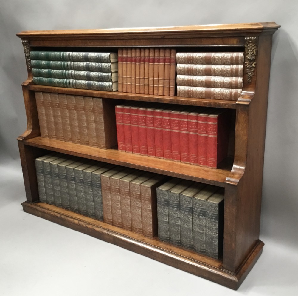 Mid C19th walnut waterfall open bookcase of neat proportions